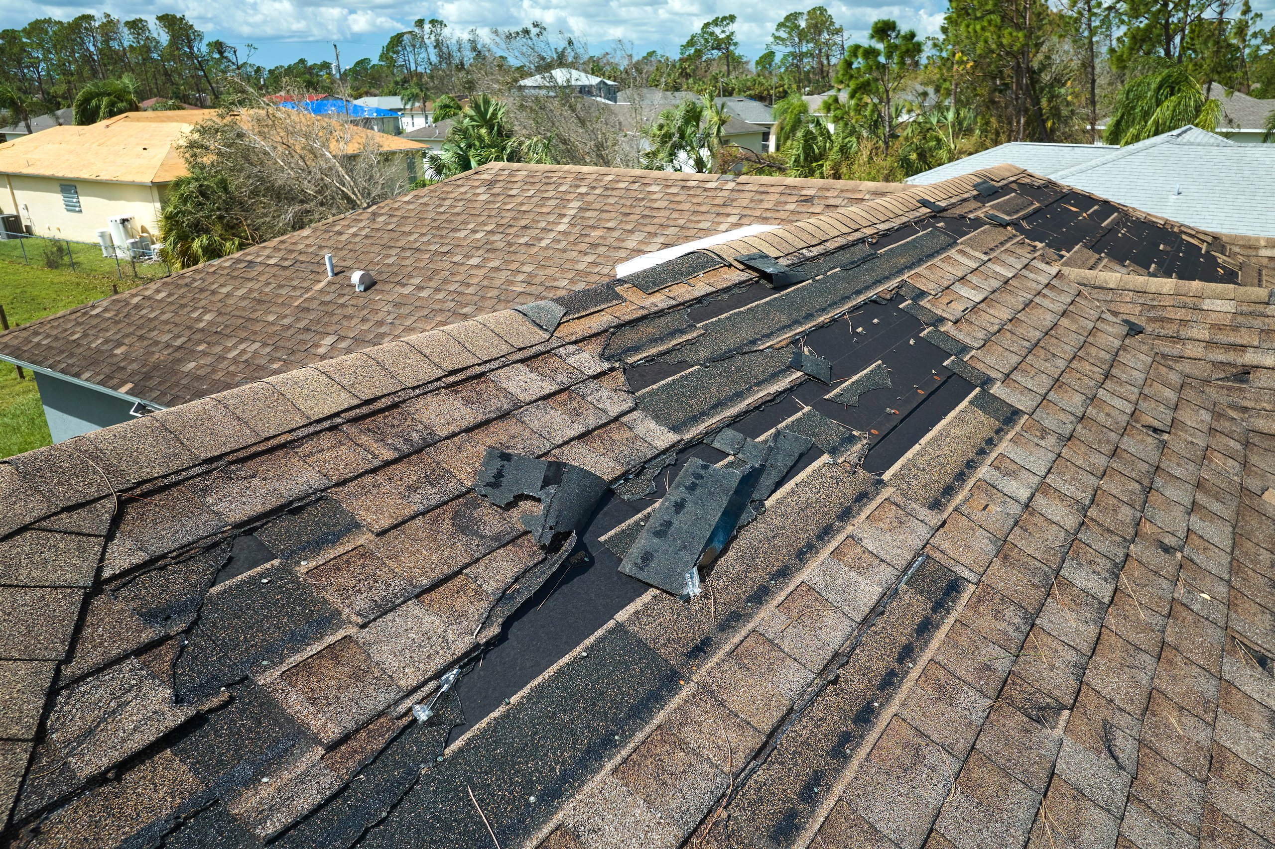 Before: Damaged shingle roof with missing shingles and leaks